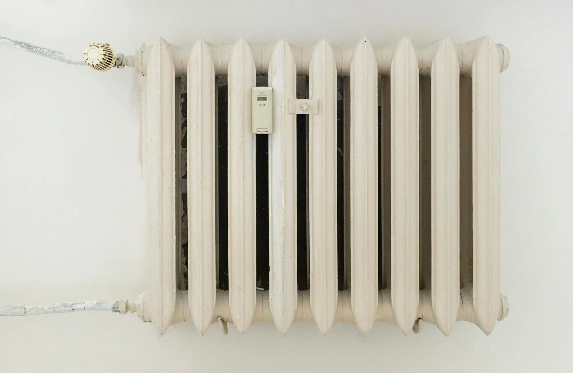 Original cast-iron Yorkshire radiator with thermostatic valve, the kind we still service across Bradford terraces